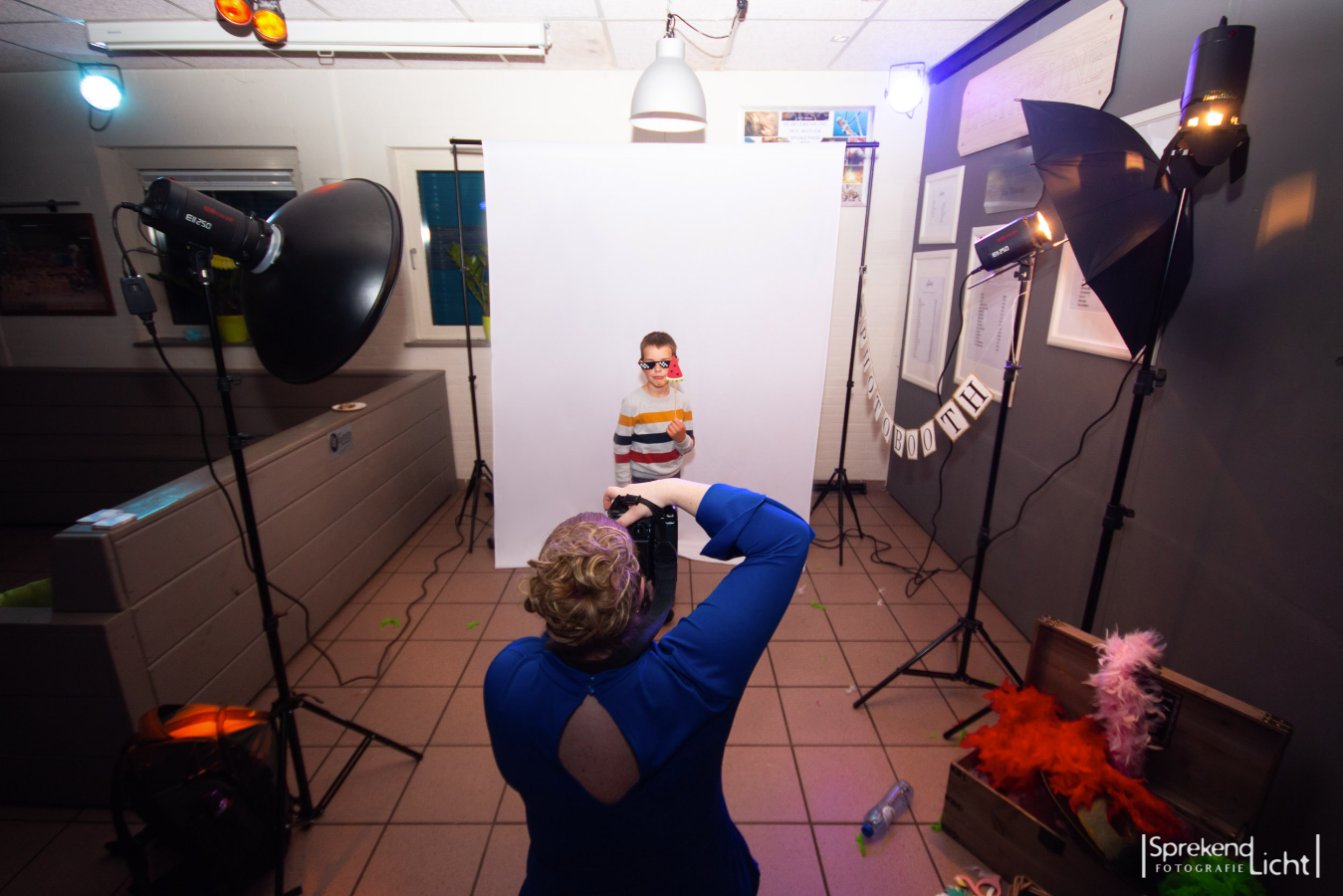 De photobooth-opstelling met flitsers en witte achtergrond